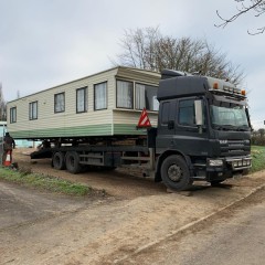 Static caravan loaded on a lorry