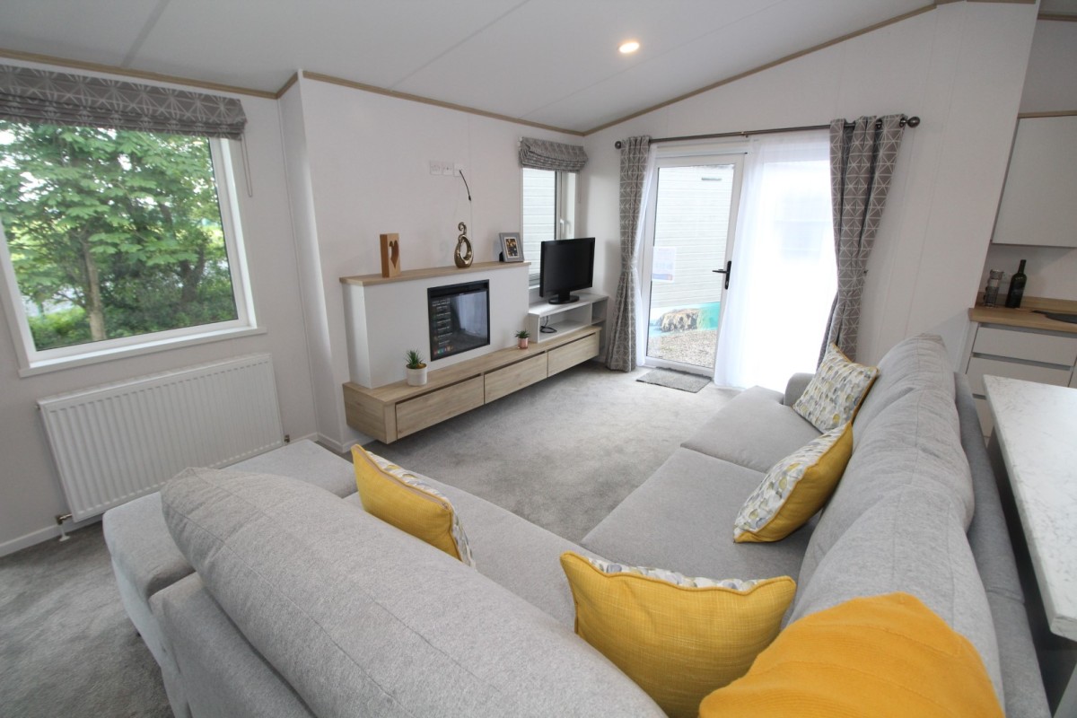 lounge to patio doors in the 2023 Atlas Oakwood Lodge 