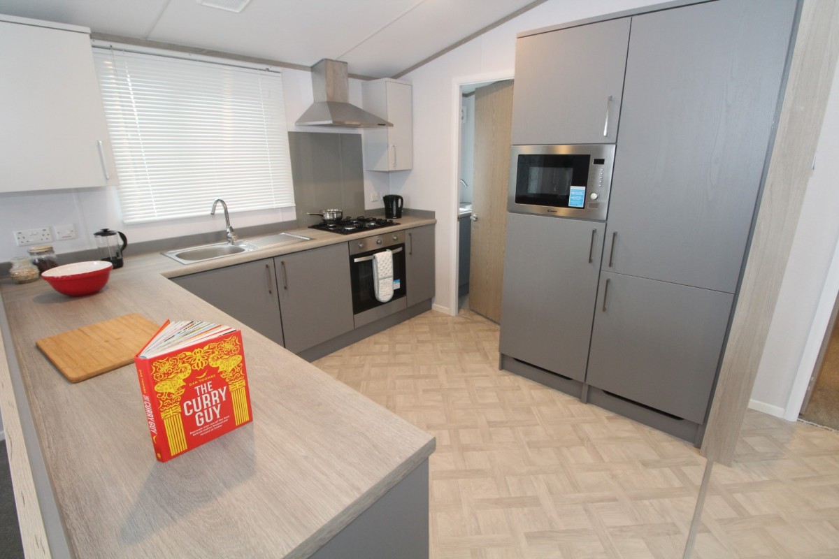 kitchen with fridge freezer in the 2023 Atlas Wisteria Lodge