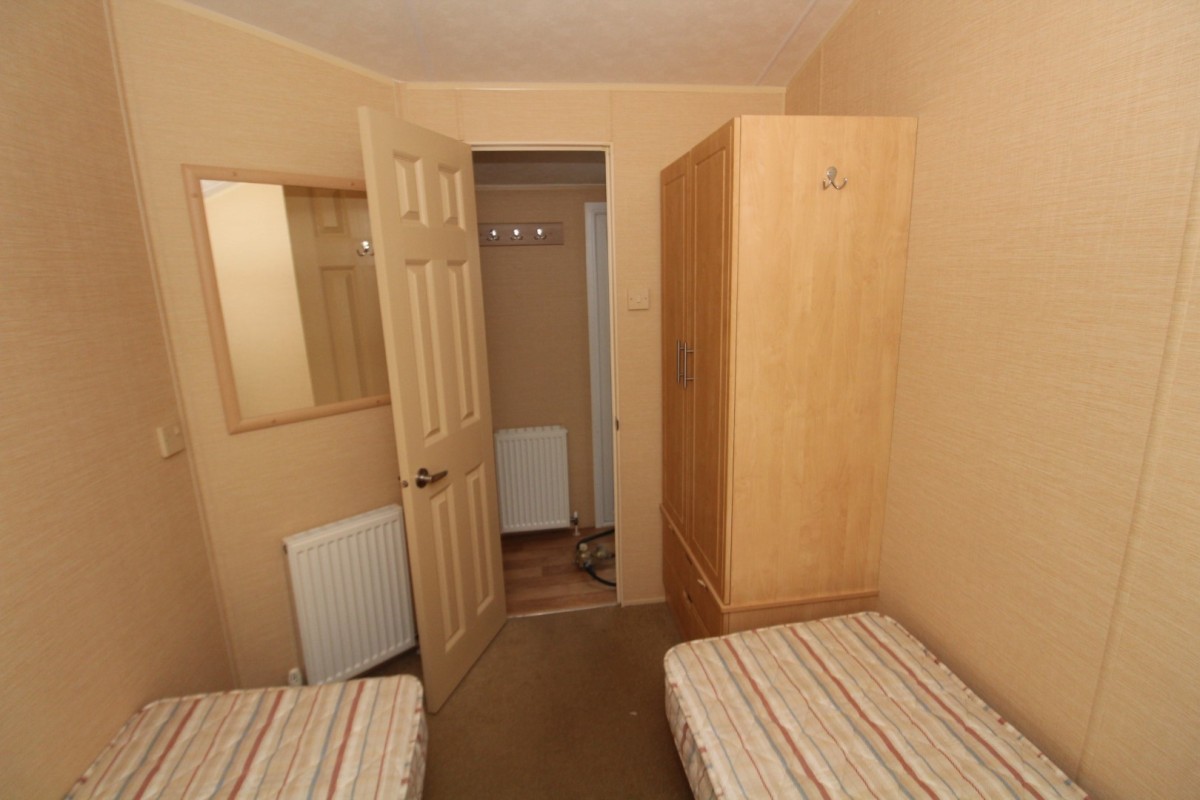 second view of the twin bedroom with cupboards