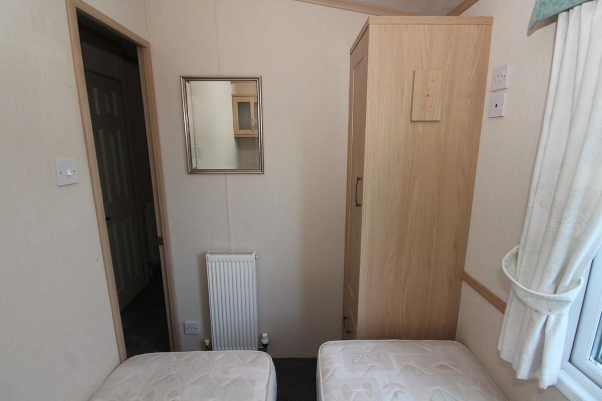 second view of the twin bedroom with central heating