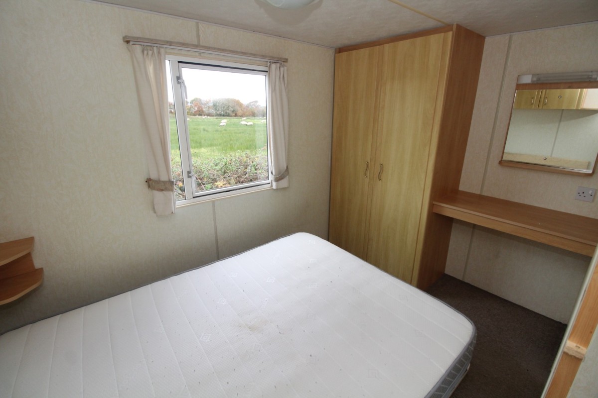 double bedroom with wardrobe and windows