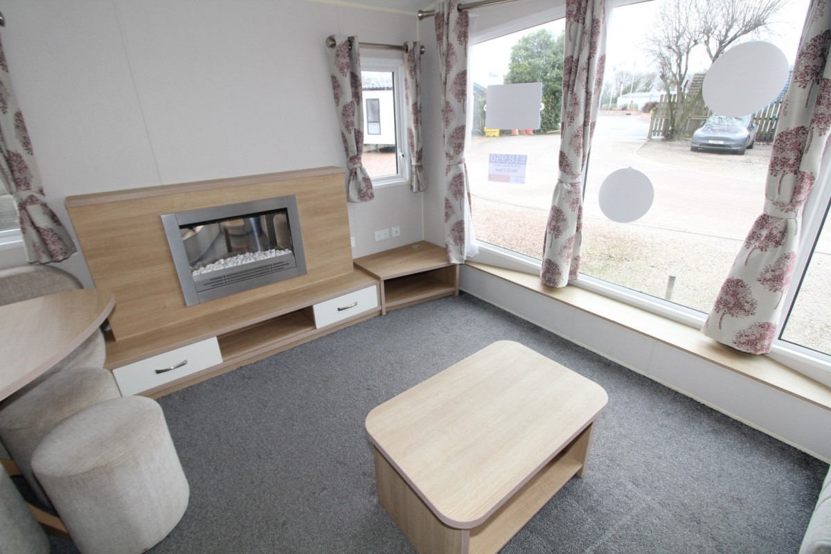 fire by coffee table in the 2016 Willerby Sierra