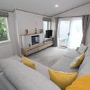 lounge to patio doors in the 2023 Atlas Oakwood Lodge 