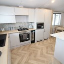 modern new kitchen in the 2023 Atlas Oakwood Lodge 