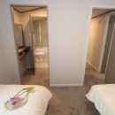 twin bedroom to en-suite in the 2023 Atlas Wisteria Lodge