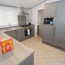 kitchen with fridge freezer in the 2023 Atlas Wisteria Lodge