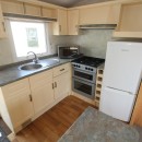 kitchen with fiull size fridge freezer in the 2007 Atlas Amethyst 