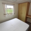 double bedroom with wardrobe and windows