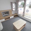 fire by coffee table in the 2016 Willerby Sierra