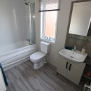 bathroom with bath in the 2018 Atlas Lilac Lodge